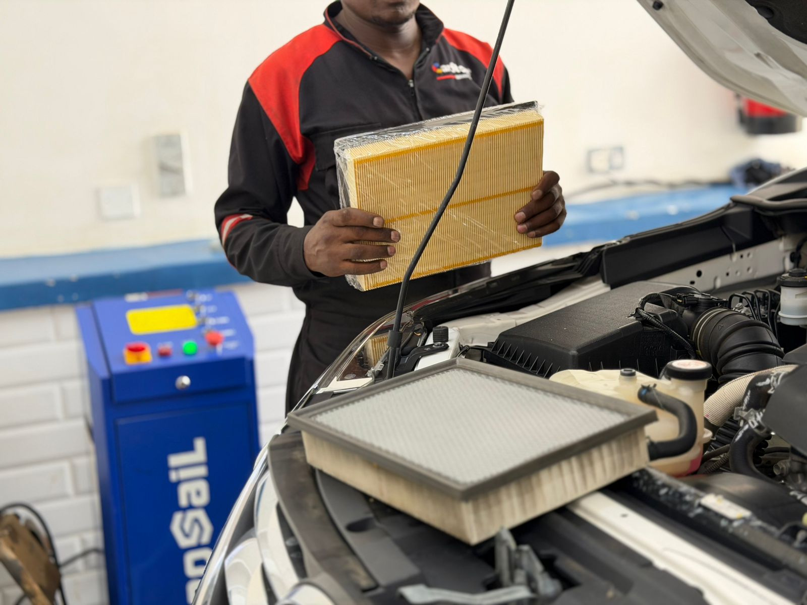 Technician replacing an engine air filter