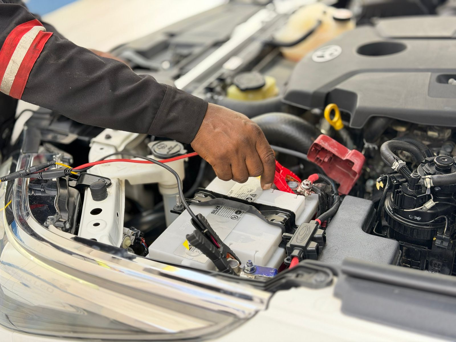 Technician testing a car battery