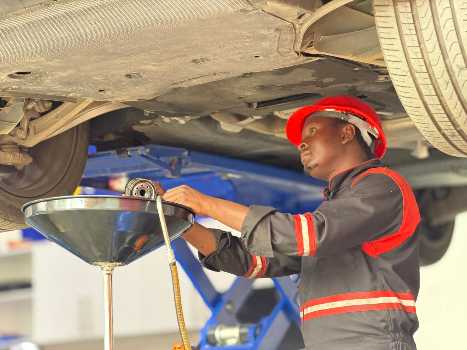 Mechanic changing engine oil and oil filter